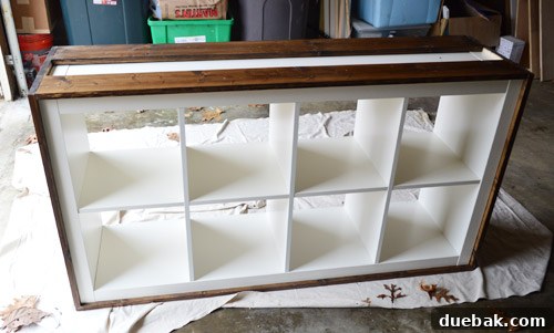 Attaching bottom wood panels to the Expedit, showing the strategically placed pieces.