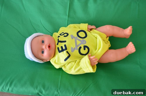 A baby onesie playfully placed on the changing pad, awaiting the baby's arrival.