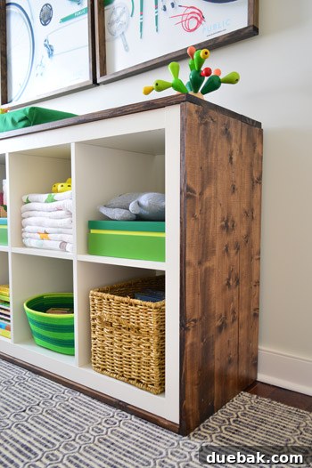 Final wide shot of the beautiful, wood-wrapped IKEA Expedit changing table in the nursery.