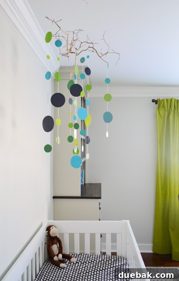 Craft Your Own Adorable Nursery Mobile 14 Detailed shot of the DIY mobile's colorful circles and natural branch