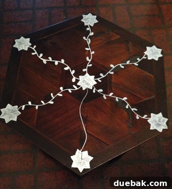 Freehand drawing wavy lines and leaves to connect the stars