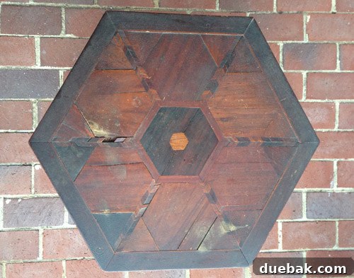 Close-up of the table showing pulled-out wood pieces due to wear