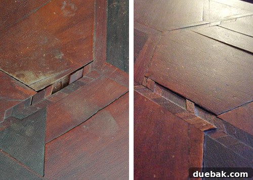 Damaged areas of the table with missing wood puzzle pieces