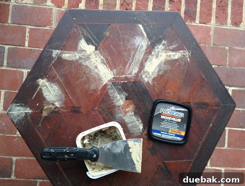 Table top with wood filler applied to damaged sections