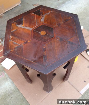 Table top after staining, showing visible lighter areas where wood putty was applied