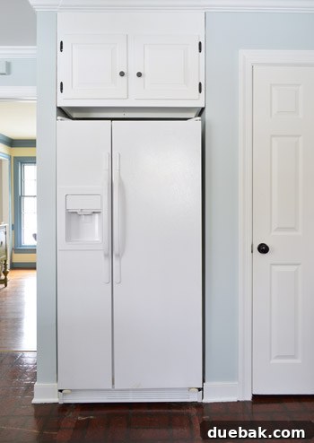 painted white refrigerator in nelson blue kitchen