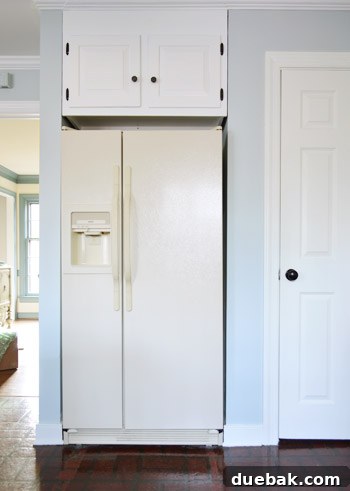 old yellow refrigerator before painting