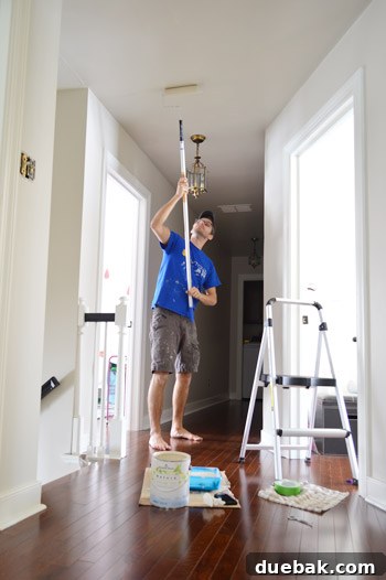 Fast Track Hallway Painting 9 Painter using a brush for cutting in around edges and trim