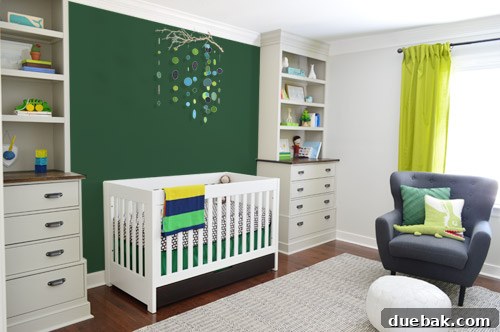 A Photoshop mock-up showing a solid bold green accent wall behind the crib in the nursery, exploring color block options.