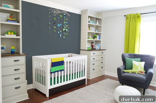 A Photoshop mock-up showcasing a solid charcoal grey accent wall behind the crib, aiming to balance the nursery's color palette.