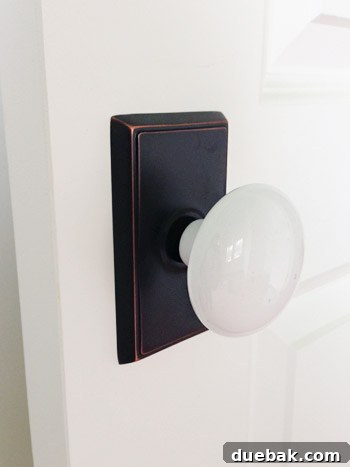 Close-up of a white porcelain doorknob with a backplate.
