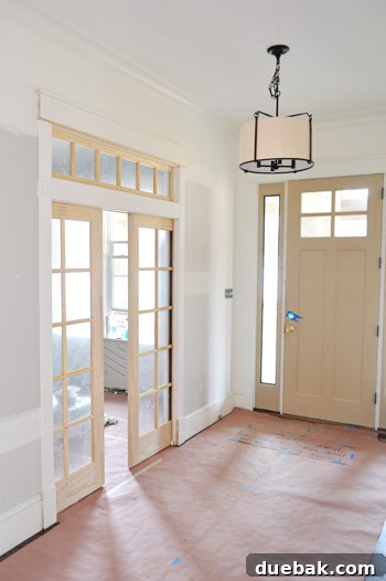 Glass pocket doors with a transom window installed in a hallway.