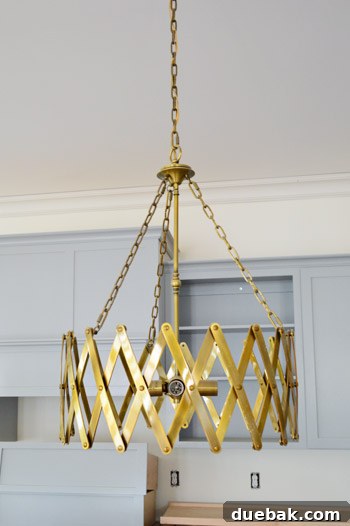 Kitchen island with unique accordion chandeliers.