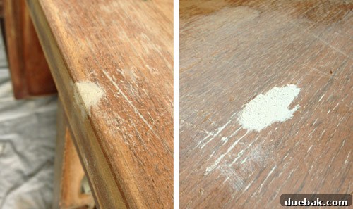 Applying wood putty to fill imperfections on the sanded desk surface.