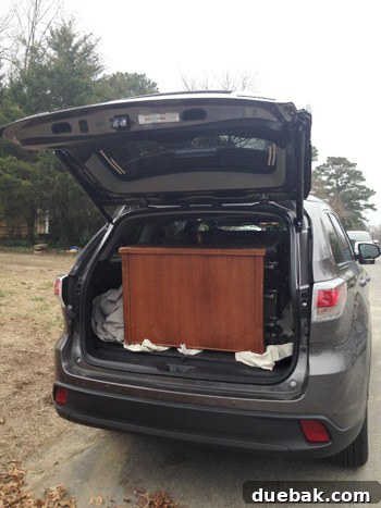 The free vintage desk successfully loaded into the car, ready for its new home.