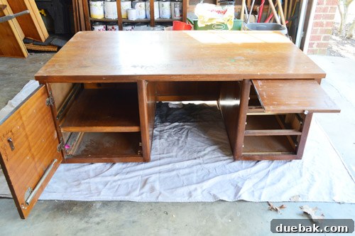 The rescued desk set up on a dropcloth, revealing its original condition and various compartments.