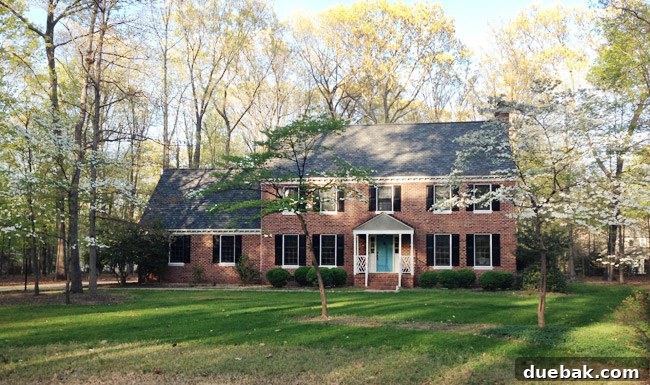 Listy VonListerstein: The Art of Intentional Listing 2 Front yard with a manicured lawn and trees, representing ongoing landscaping projects.