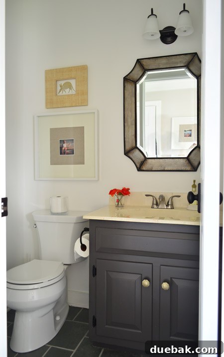 Listy VonListerstein: The Art of Intentional Listing 7 Updated half bathroom with new mirror, painted vanity, and updated lighting.