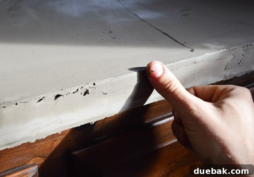 Smoothing Ardex edges with a damp finger