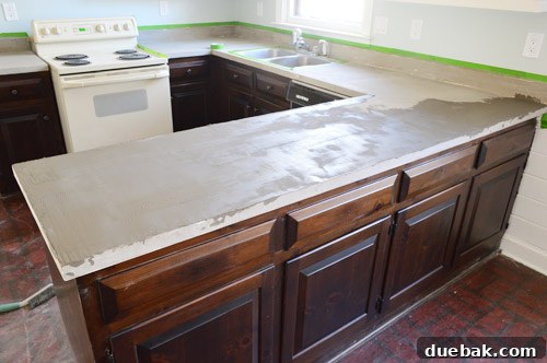 Applying a second coat of Ardex, showing wet vs. dry color difference