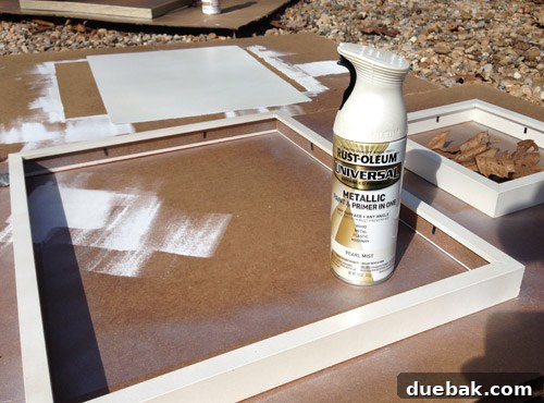Build Your Own Magnetic Display Board 13 Applying pearl mist spray paint to the frames and prepared metal sheets, with other colors drying in the background