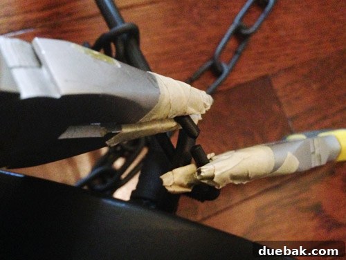 Close-up of pliers wrapped in masking tape to protect the chain during shortening