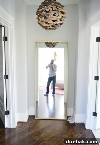 Showhouse Styling 20 Main bedroom atrium with brass floor mirror and branch chandelier