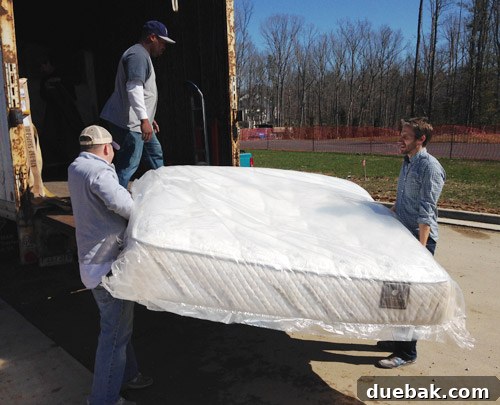 Showhouse Styling 3 Team members moving a large sofa into the showhouse living area
