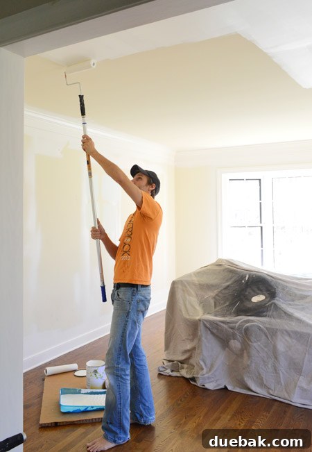 Paint Your Room Like A Professional 4 John Applying Paint to Ceiling With Roller On Extension Pole