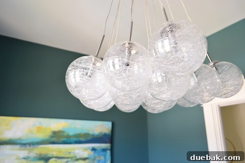 Crafting the Dream Showhouse 13 A unique spun glass chandelier hanging in a room with a window, creating a challenge for photography.