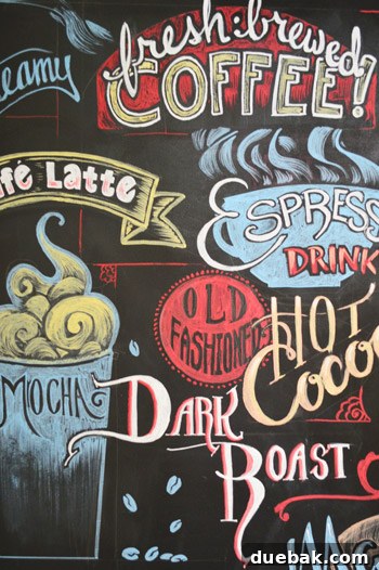 Crafting the Dream Showhouse 16 A butler's pantry with a chalkboard wall featuring a coffee and wine themed mural.