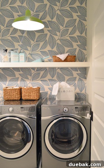 Crafting the Dream Showhouse 8 A laundry room featuring a newly installed white floating shelf and wallpaper.