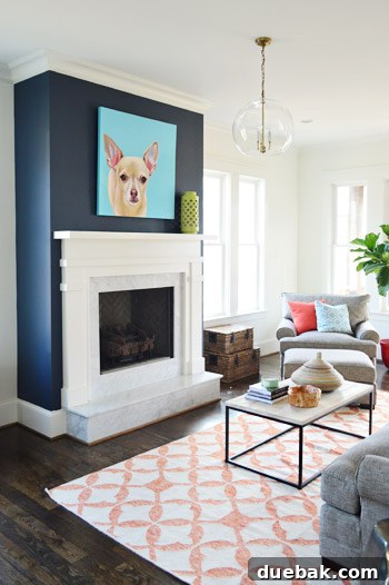 Crafting the Dream Showhouse 10 A living room featuring a large, unique portrait of a pet dog above the fireplace.