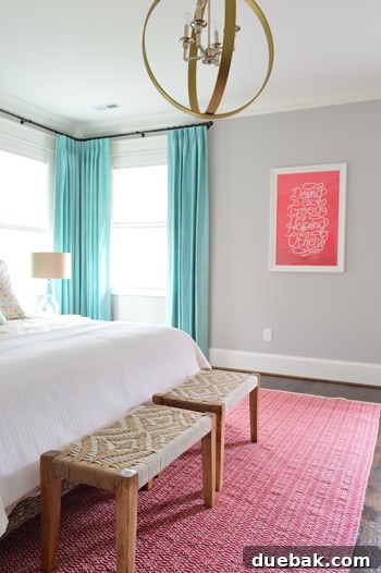 Woven benches at foot of master bed with framed art