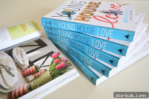 A stack of the Young House Love paperback book, an exclusive edition for Target stores, placed alongside other home improvement items.
