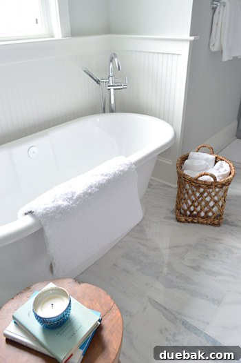 Tub area with beadboard wainscoting and Delta tub filler