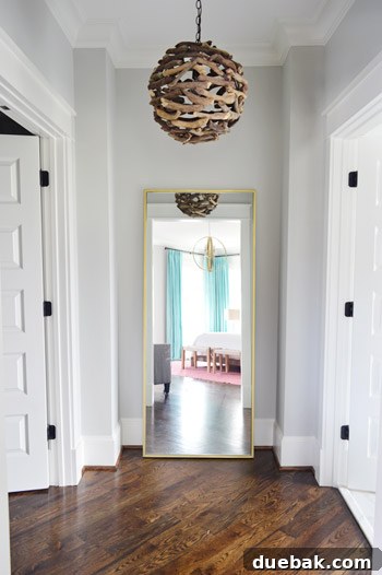 Brass floor mirror and driftwood light in the atrium