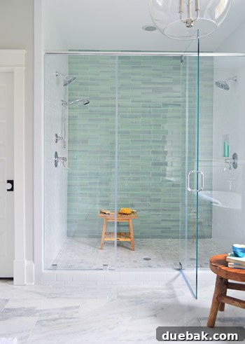 Aqua glass tile accent wall in the shower
