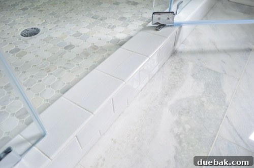 Shower floor tile with aqua accents and marble bathroom floor
