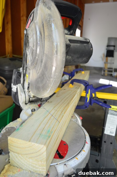 Using Miter Saw To Cut 2x4 Pressure Treated Boards For Deck Gate Frame