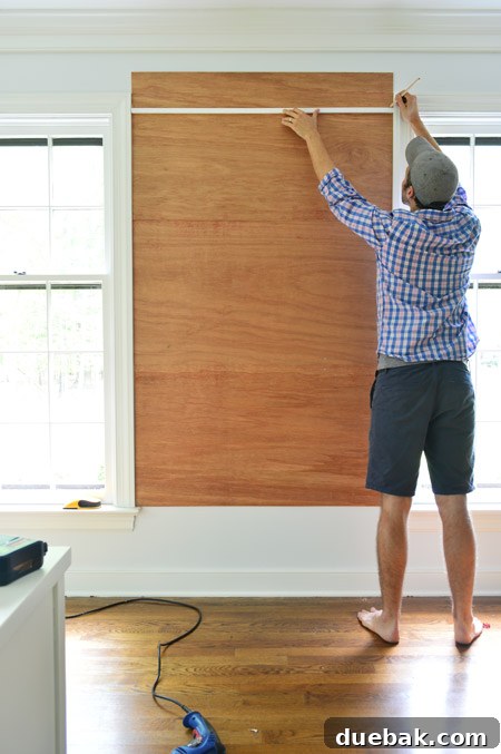 marking cut for top plywood piece for cork board wall so that it doesn't extend higher than the window frame