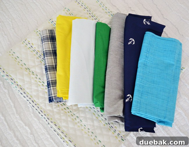 A selection of fabric backdrops for Teddy's weekly baby photos, including a handmade quilt.