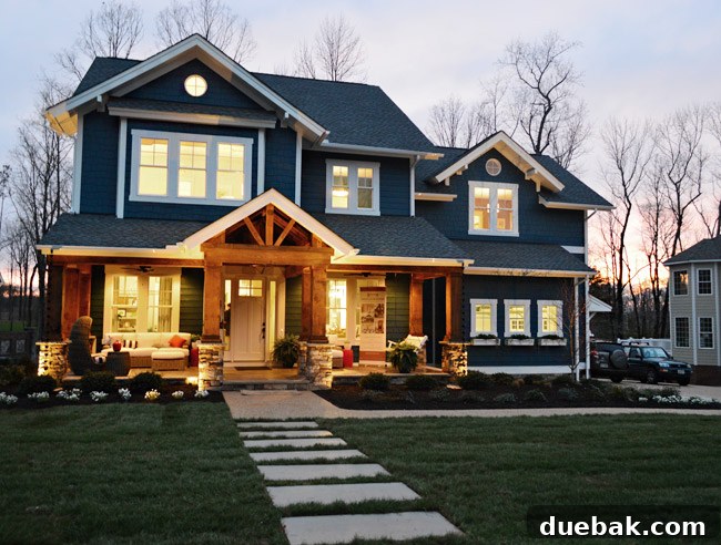 Exterior view of the showhouse from the street, showcasing the front porch, landscaping, and overall curb appeal.