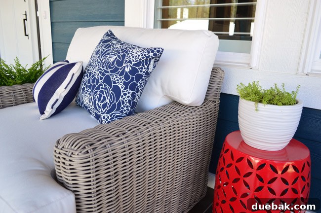 Arhaus swivel chair positioned next to the porch swing, offering flexible seating.