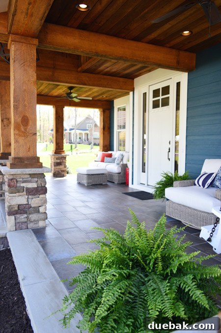 Potted ferns on the front porch, adding greenery and life to the space.