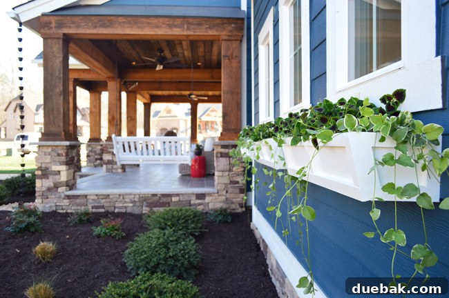 Custom-built window boxes adorning the garage side of the house, adding charm and greenery.