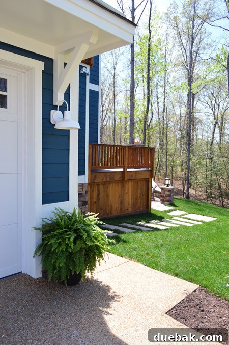 Limestone pathway extending around the side of the garage, leading to the backyard patio.