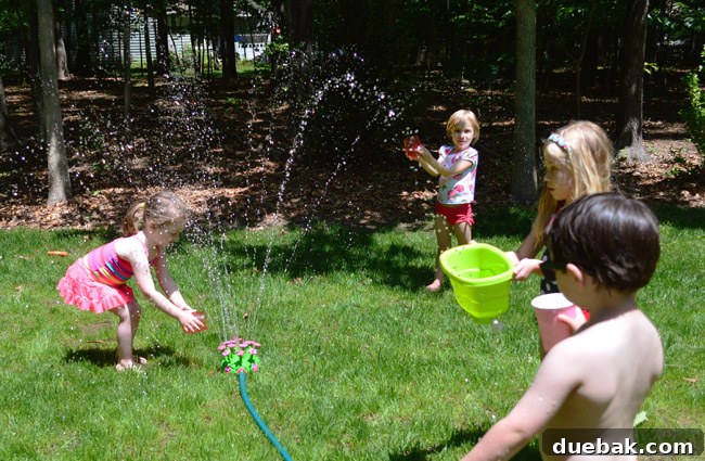 The Ultimate Pink and Gold Kids Celebration 16 Kids playing with sprinkler