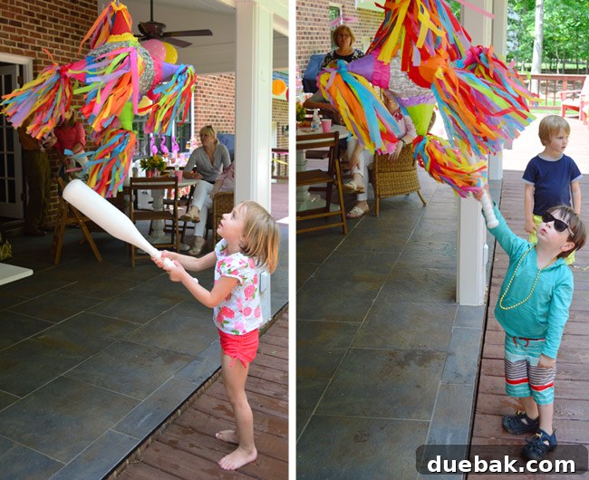 The Ultimate Pink and Gold Kids Celebration 20 Kids hitting piñata
