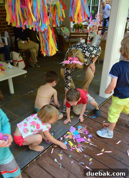 The Ultimate Pink and Gold Kids Celebration 21 Kids scrambling for piñata candy